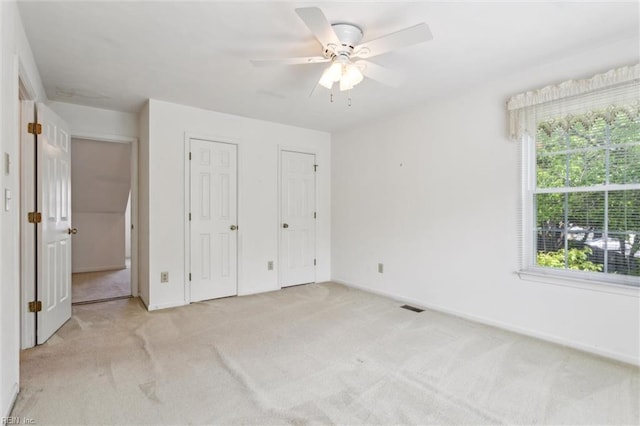 6017 Glen View Dr, Virginia Beach, VA 23464 - unfurnished bedroom with light colored carpet, two closets, baseboards, and ceiling fan