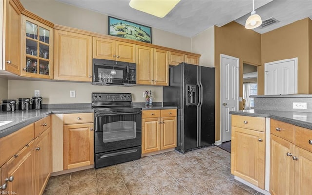 kitchen featuring black appliances, glass insert cabinets, dark countertops, and light tile patterned floors