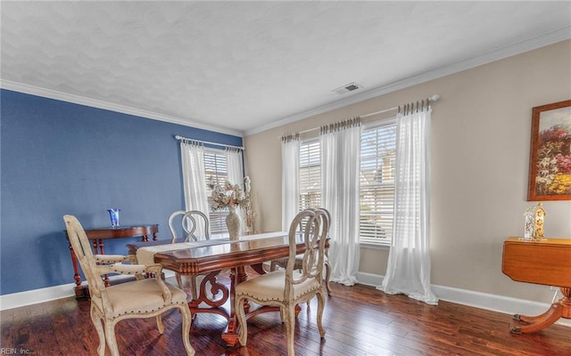 dining room with baseboards, wood-type flooring, and ornamental molding