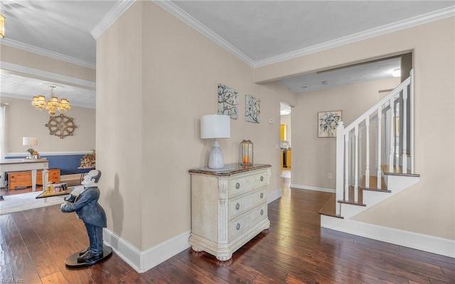 entrance foyer featuring a chandelier, baseboards, dark wood-style floors, and ornamental molding