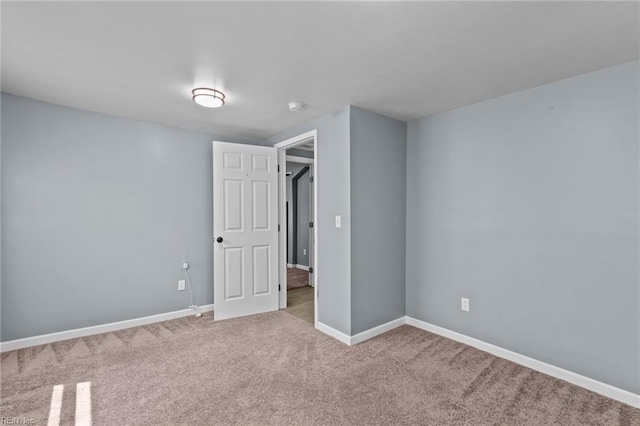 unfurnished bedroom with carpet floors and baseboards