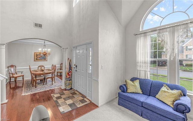 2230 Angler Ln, Chesapeake, VA 23323 - entrance foyer featuring arched walkways, ornate columns, a chandelier, high vaulted ceiling, and wood finished floors