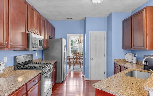 2230 Angler Ln, Chesapeake, VA 23323 - kitchen featuring stainless steel appliances, a sink, a chandelier, dark wood-style flooring, and light stone counters