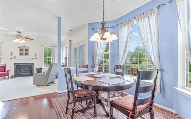2230 Angler Ln, Chesapeake, VA 23323 - dining room with baseboards, hardwood / wood-style flooring, a chandelier, and a glass covered fireplace