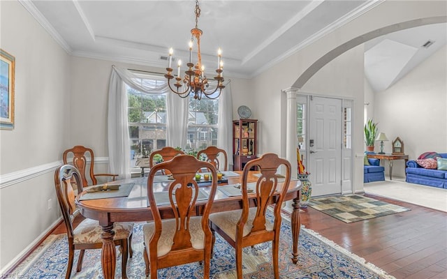 2230 Angler Ln, Chesapeake, VA 23323 - dining area featuring a chandelier, arched walkways, hardwood / wood-style flooring, a raised ceiling, and crown molding