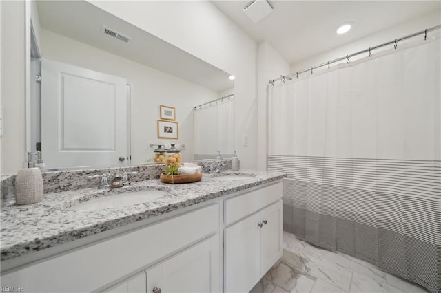 104 Genoa Dr, Elizabeth City, NC 27909 - full bathroom featuring marble look tiles, double vanity, and recessed lighting