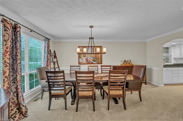 2537 Springhaven Dr, Virginia Beach, VA 23456 - dining area featuring arched walkways, crown molding, baseboards, a chandelier, and light carpet