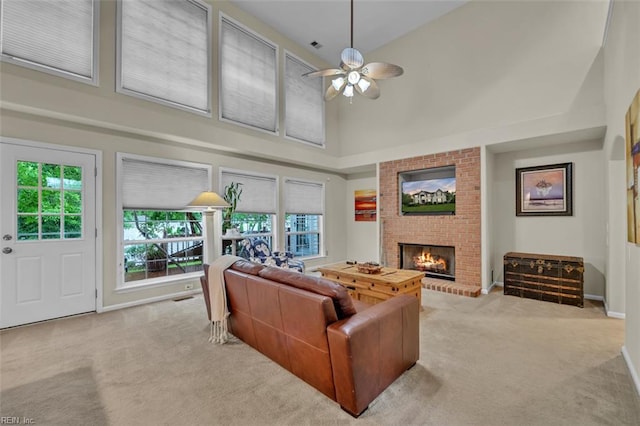 2537 Springhaven Dr, Virginia Beach, VA 23456 - carpeted living area featuring high vaulted ceiling, ceiling fan, a brick fireplace, and baseboards