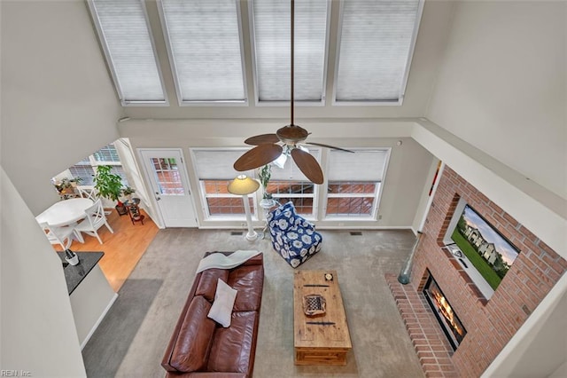 2537 Springhaven Dr, Virginia Beach, VA 23456 - living area with a fireplace, healthy amount of natural light, a ceiling fan, a towering ceiling, and wood finished floors