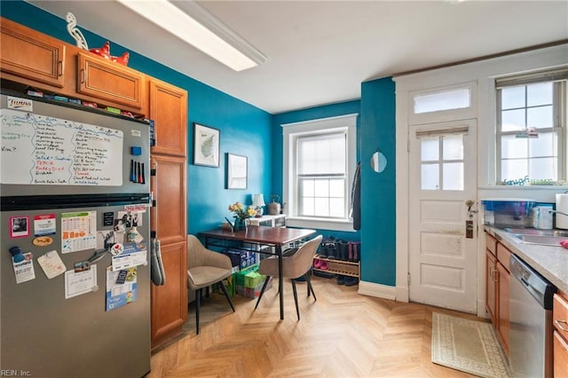 913 Spotswood Ave Unit 1, Norfolk, VA 23517 - kitchen featuring appliances with stainless steel finishes, brown cabinetry, a sink, and baseboards