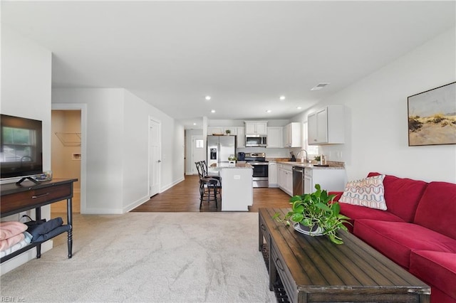 6729 Nolan Run, Gloucester, VA 23061 - living area featuring light colored carpet, baseboards, and recessed lighting