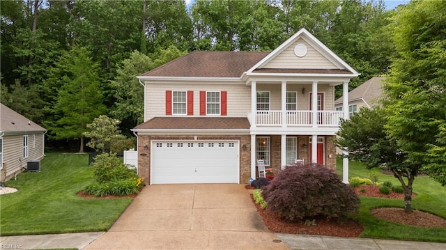 2968 Elegance Ln, Virginia Beach, VA 23456 - greek revival house featuring a garage, covered porch, driveway, a front yard, and brick siding