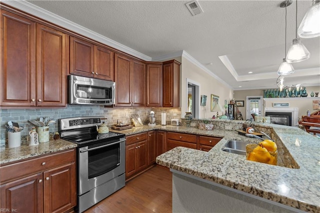 2968 Elegance Ln, Virginia Beach, VA 23456 - kitchen with stainless steel appliances, a sink, wood finished floors, ornamental molding, and light stone counters
