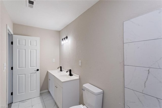 503 Middlesex St, Norfolk, VA 23523 - bathroom with marble finish flooring, toilet, vanity, and a textured wall