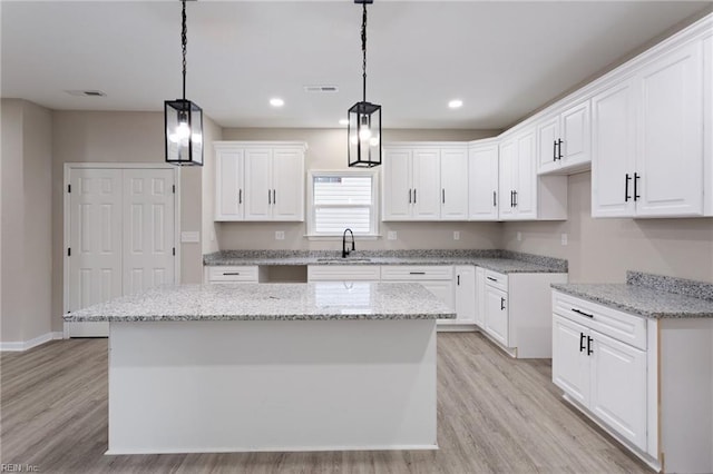 503 Middlesex St, Norfolk, VA 23523 - kitchen with a sink, light wood finished floors, light stone countertops, white cabinetry, and recessed lighting
