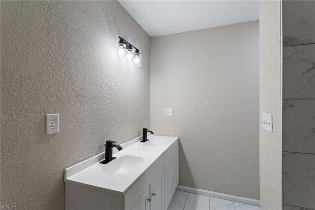 503 Middlesex St, Norfolk, VA 23523 - full bath featuring marble look tile flooring, double vanity, baseboards, and a textured wall