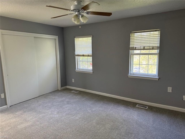 719 Tilden Pl, Virginia Beach, VA 23454 - unfurnished bedroom with carpet flooring, a textured ceiling, a closet, baseboards, and a ceiling fan