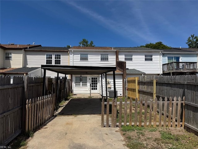 719 Tilden Pl, Virginia Beach, VA 23454 - rear view of property with cooling unit, a carport, concrete driveway, and a fenced backyard