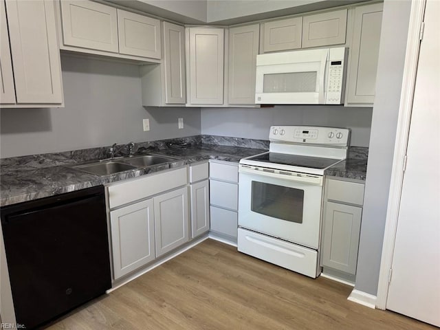 719 Tilden Pl, Virginia Beach, VA 23454 - kitchen with white appliances, a sink, light wood-style floors, and dark countertops