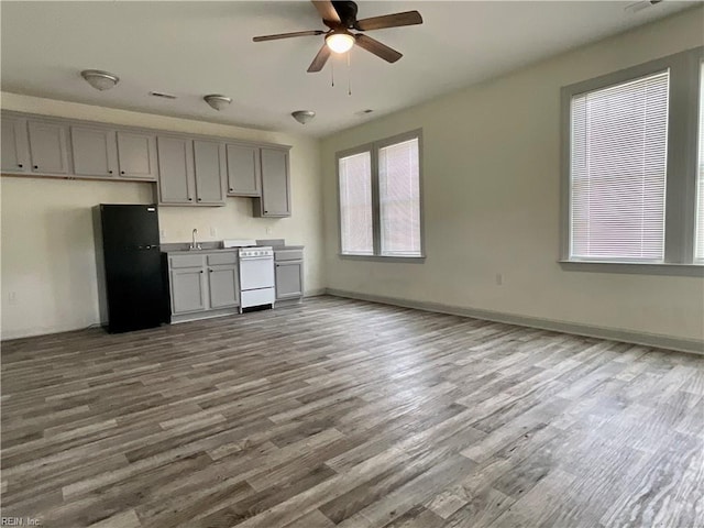 103 Lawrence Dr, Elizabeth City, NC 27909 - kitchen featuring freestanding refrigerator, gray cabinets, white range oven, a ceiling fan, and dark wood-style floors