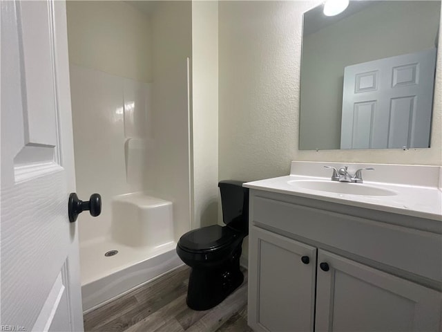 103 Lawrence Dr, Elizabeth City, NC 27909 - full bathroom featuring wood finished floors, a shower, vanity, toilet, and a textured wall