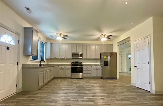 103 Lawrence Dr, Elizabeth City, NC 27909 - kitchen with appliances with stainless steel finishes, a ceiling fan, and wood finished floors