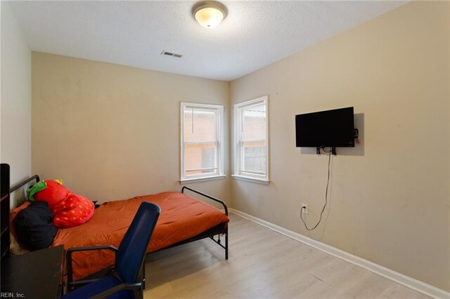 117 Bute St, Suffolk, VA 23434 - bedroom with wood finished floors, baseboards, and a textured ceiling