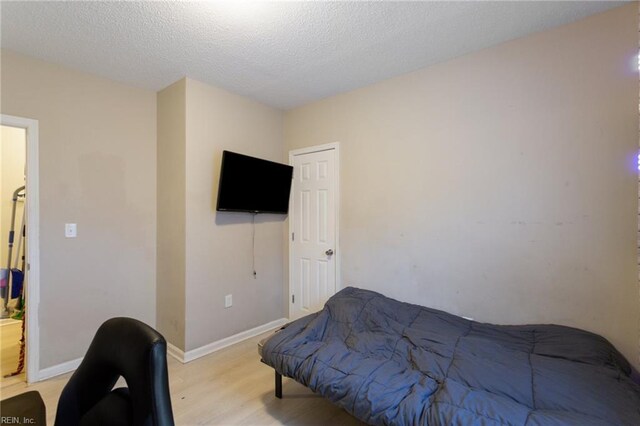 117 Bute St, Suffolk, VA 23434 - bedroom with light wood-type flooring, baseboards, and a textured ceiling