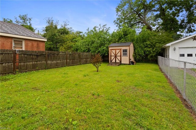 117 Bute St, Suffolk, VA 23434 - view of yard with an outdoor structure, a garage, and a storage unit