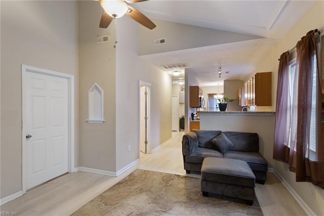 117 Bute St, Suffolk, VA 23434 - living area with ceiling fan, light wood-style floors, high vaulted ceiling, and baseboards
