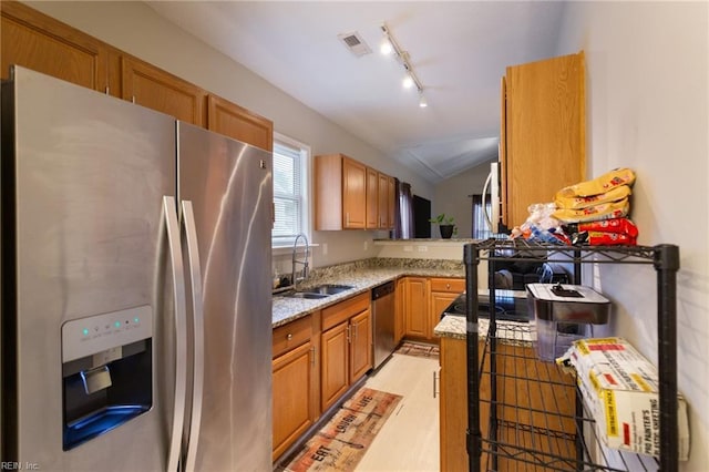 117 Bute St, Suffolk, VA 23434 - kitchen featuring stainless steel appliances, a sink, light stone counters, track lighting, and lofted ceiling