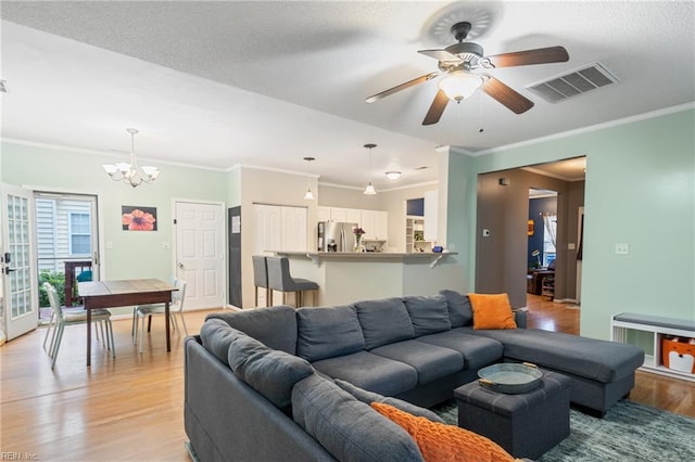 5049 Kelso St, Suffolk, VA 23435 - living area featuring light wood-style floors, a chandelier, ceiling fan, ornamental molding, and a textured ceiling