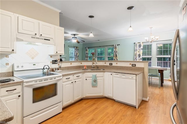 5049 Kelso St, Suffolk, VA 23435 - kitchen with white appliances, under cabinet range hood, a sink, a chandelier, and light countertops