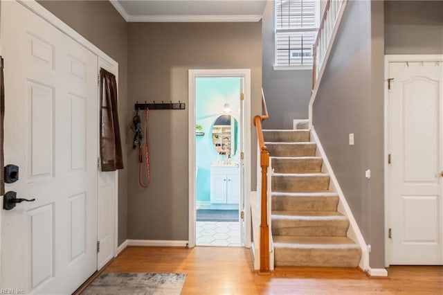 5049 Kelso St, Suffolk, VA 23435 - entryway with wood finished floors, stairway, baseboards, and ornamental molding