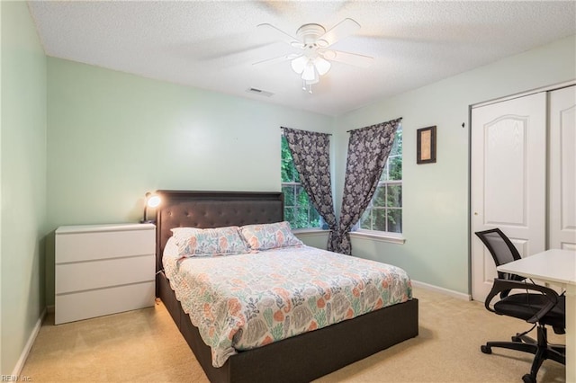5049 Kelso St, Suffolk, VA 23435 - carpeted bedroom with baseboards, a ceiling fan, a textured ceiling, a closet, and a desk