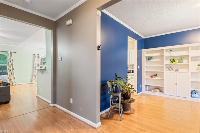 5049 Kelso St, Suffolk, VA 23435 - hallway with light wood-style floors, crown molding, a textured ceiling, and baseboards