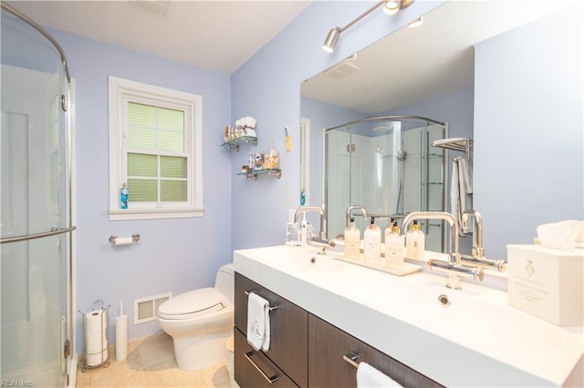 full bathroom with a shower stall, toilet, vanity, and tile patterned floors