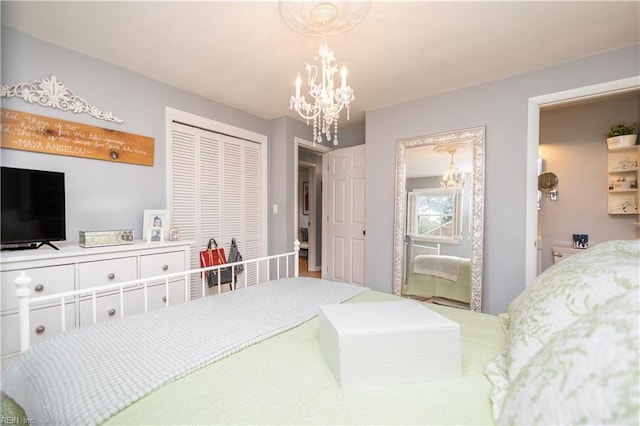 bedroom featuring a chandelier and a closet