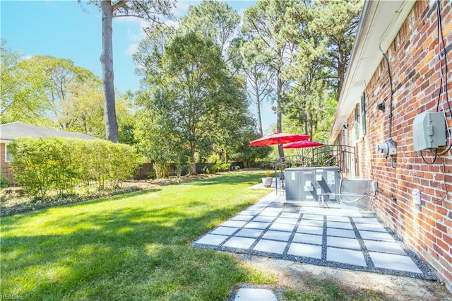 view of grassy yard with a patio