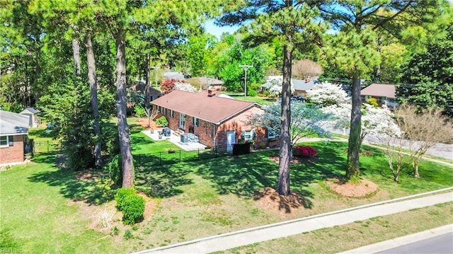 view of subject property with a tree filled landscape