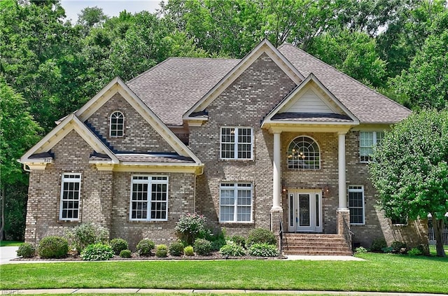 840 Forest Glade Dr, Chesapeake, VA 23322 - neoclassical home featuring brick siding, a front lawn, and a shingled roof
