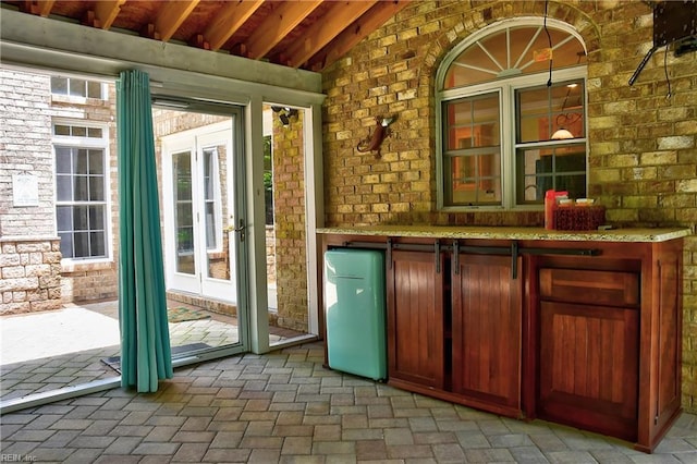 840 Forest Glade Dr, Chesapeake, VA 23322 - bar area featuring brick wall, brick flooring, and lofted ceiling