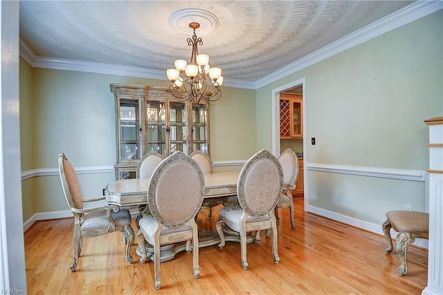 840 Forest Glade Dr, Chesapeake, VA 23322 - dining area featuring a chandelier, baseboards, wood finished floors, and crown molding