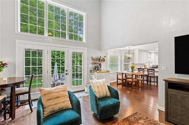 527 Lakeshead Dr, Williamsburg, VA 23185 - living room with a towering ceiling, wood finished floors, french doors, and a chandelier