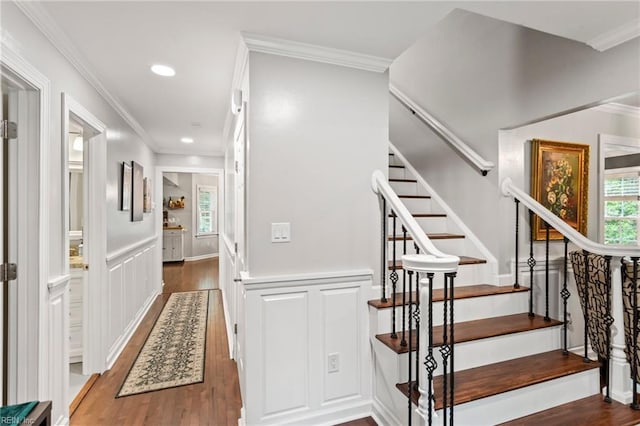 527 Lakeshead Dr, Williamsburg, VA 23185 - staircase featuring plenty of natural light, wood finished floors, ornamental molding, a wainscoted wall, and a decorative wall