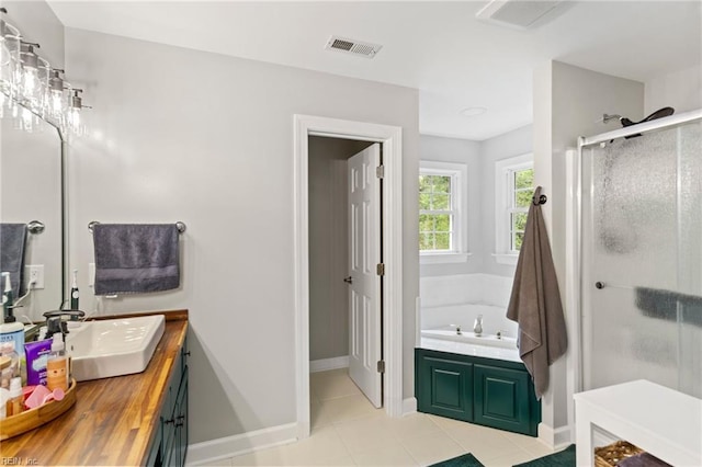 527 Lakeshead Dr, Williamsburg, VA 23185 - full bath featuring vanity, a shower stall, a bath, tile patterned flooring, and baseboards