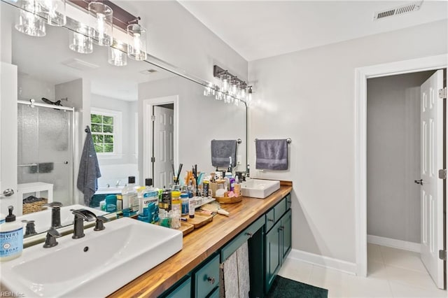 527 Lakeshead Dr, Williamsburg, VA 23185 - full bathroom with a shower stall, tile patterned floors, double vanity, and baseboards