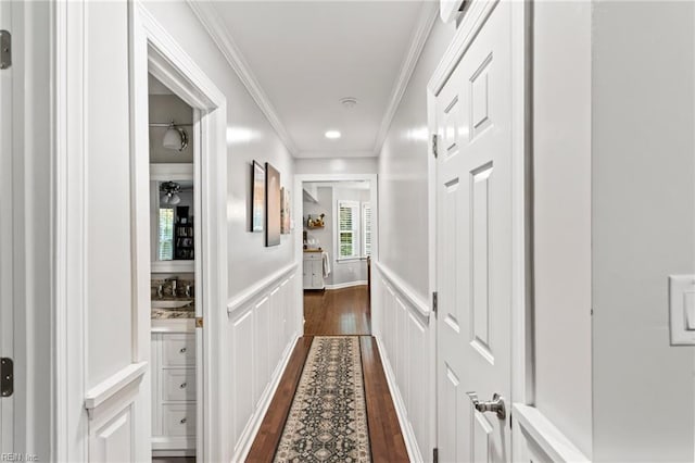 527 Lakeshead Dr, Williamsburg, VA 23185 - hall with dark wood-style floors, crown molding, a decorative wall, wainscoting, and recessed lighting
