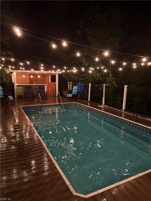 527 Lakeshead Dr, Williamsburg, VA 23185 - pool at night featuring fence and a deck