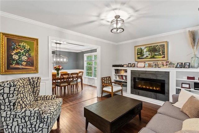 527 Lakeshead Dr, Williamsburg, VA 23185 - living area featuring ornamental molding, wood-type flooring, a chandelier, a fireplace, and wainscoting